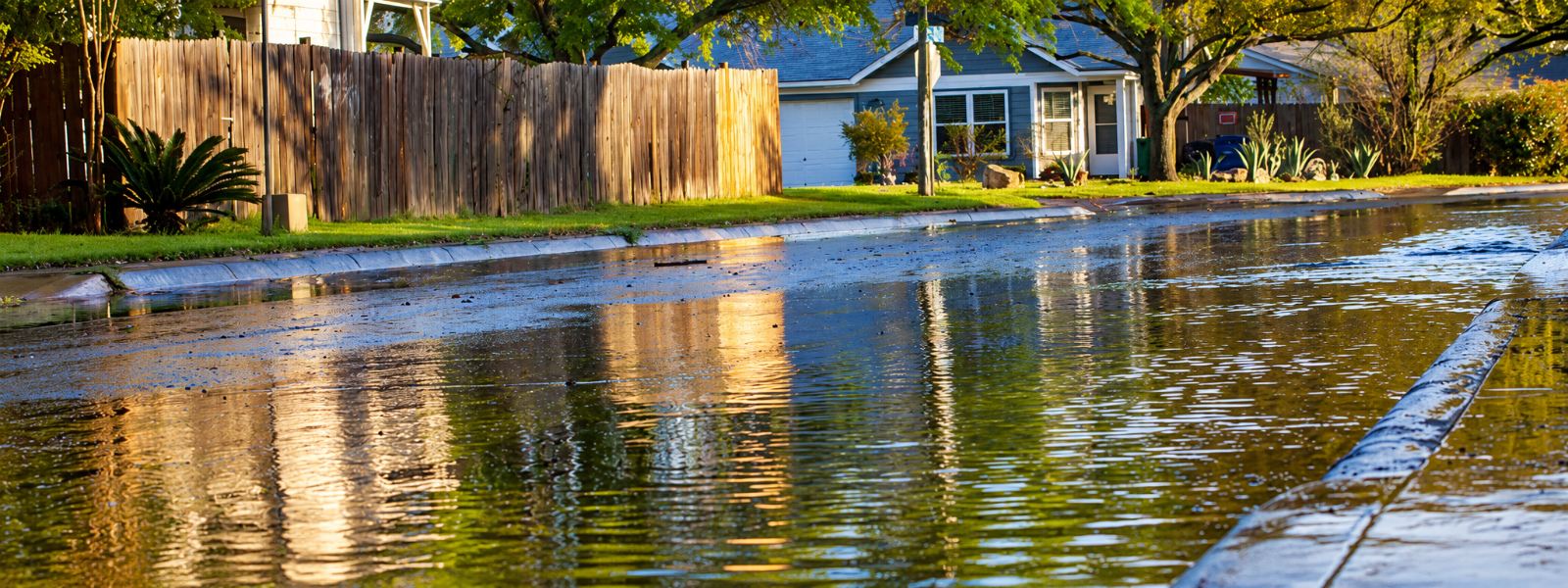 Residential home surrounded by floodwater illustrating flood insurance coverage
